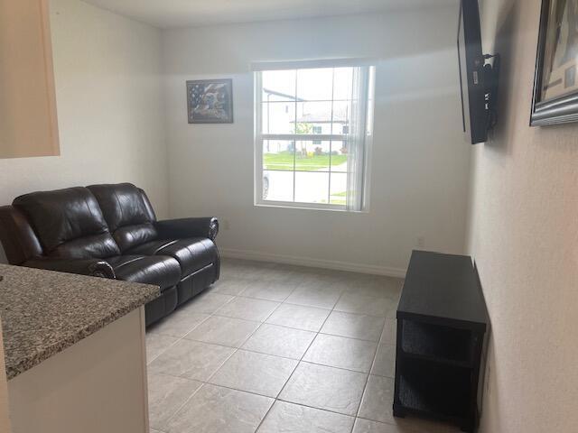 5133 Armina Place, Unit STUDIO Fort Pierce, FL 34951 - Photo 6 of 18 a living room with furniture and a window