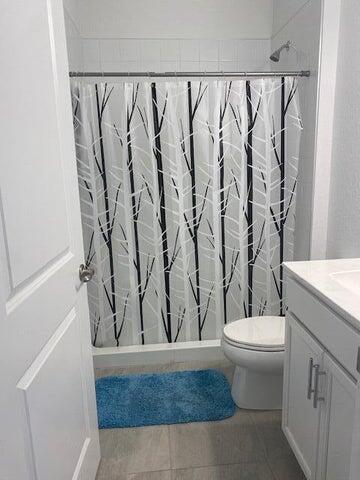 5133 Armina Place, Unit STUDIO Fort Pierce, FL 34951 - Photo 10 of 18 a bathroom with a granite countertop sink and a mirror