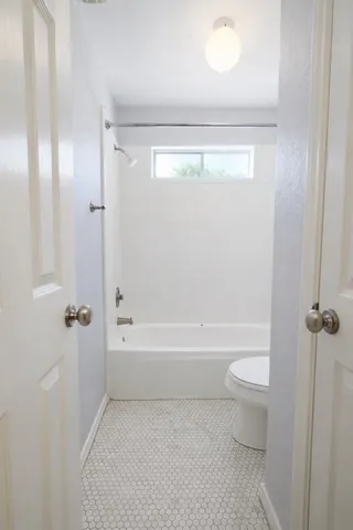 a view of a house with a yard and fence