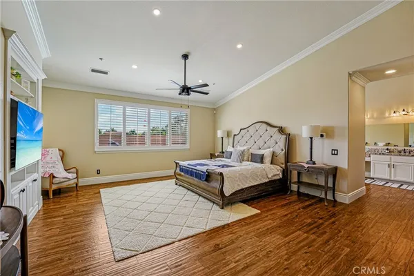 a bedroom that has a bed and a flat screen television