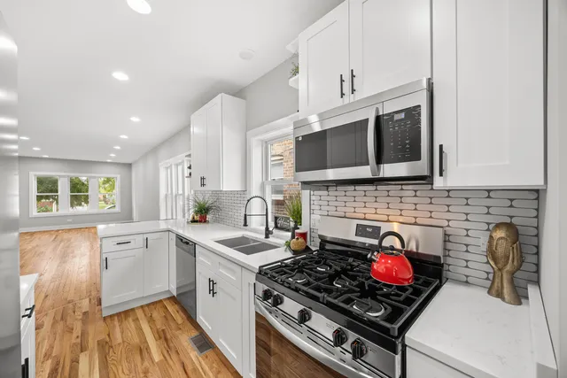 a kitchen with a stove a sink and a microwave