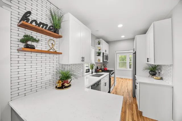 a white table sitting in a kitchen next to a window