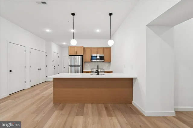 a view of a kitchen with wooden floor