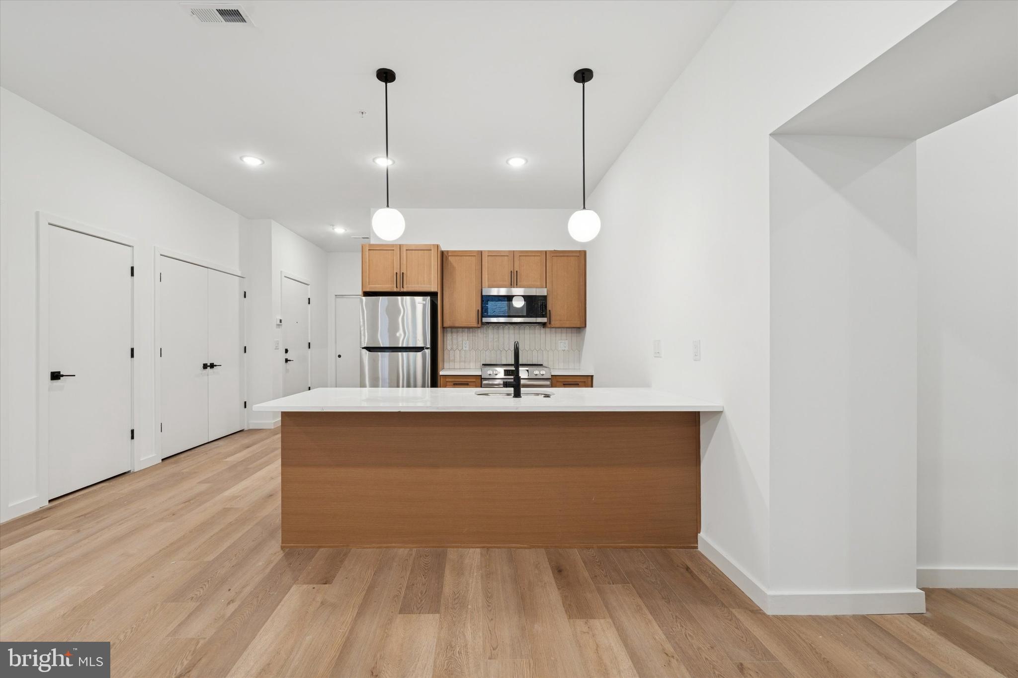 754 South 4th Street, Unit 101 Philadelphia, PA 19147 - Photo 3 of 14 a view of a kitchen with wooden floor
