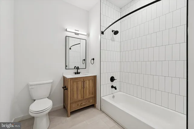 a bathroom with a sink a toilet and bathtub