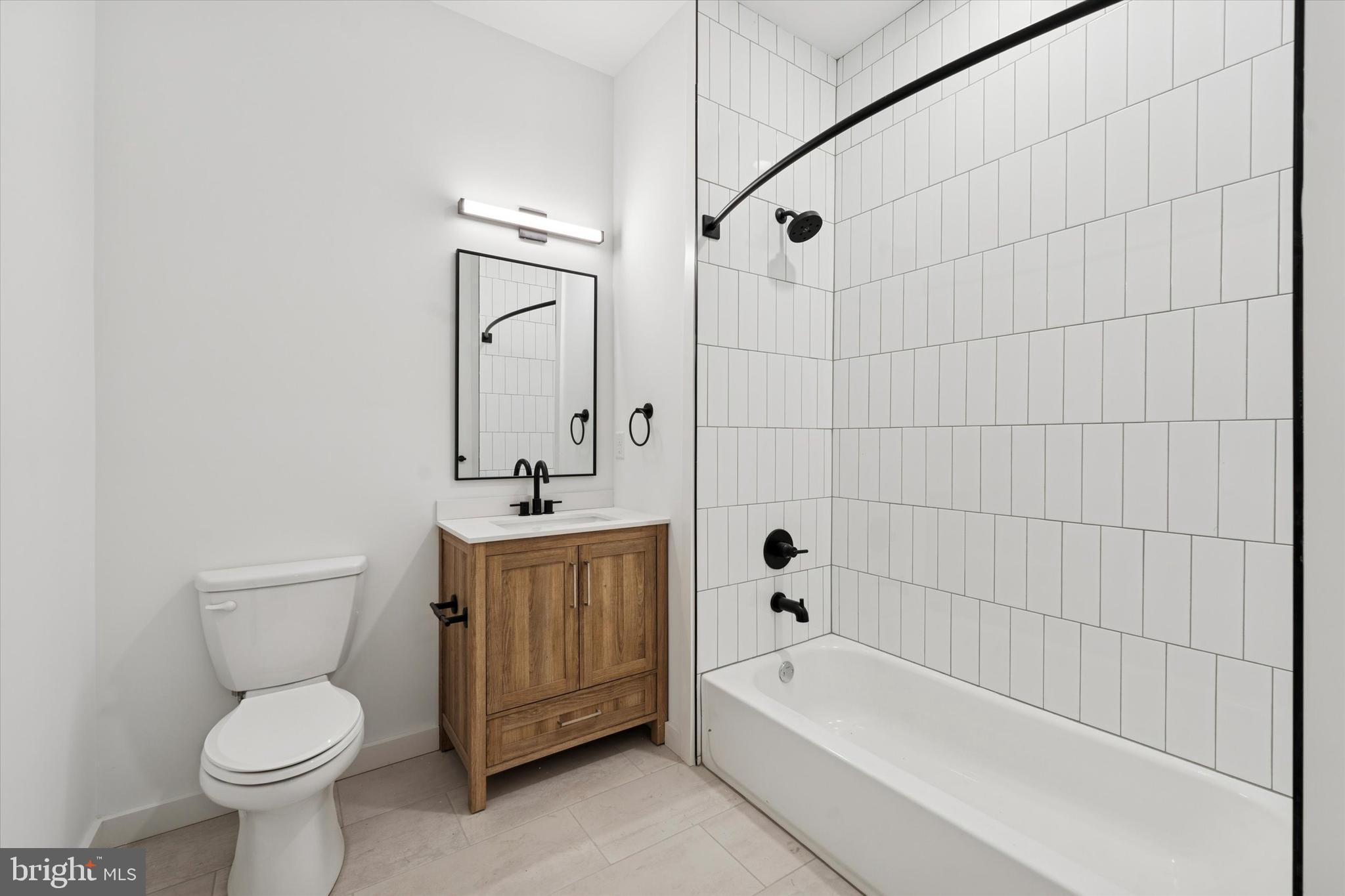 754 South 4th Street, Unit 101 Philadelphia, PA 19147 - Photo 8 of 14 a bathroom with a sink a toilet and bathtub