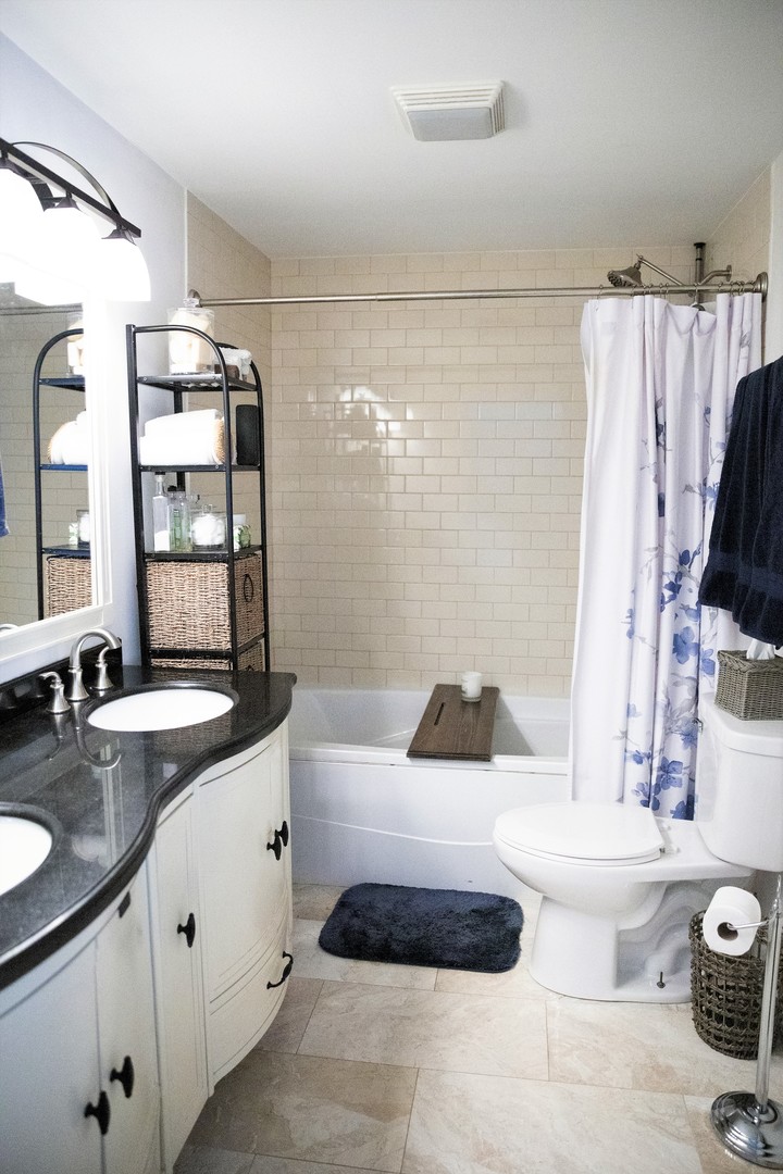 2119 Fairfield Road Lindenhurst, IL 60046 - Photo 13 of 22 a bathroom with a granite countertop sink a toilet a mirror and shower