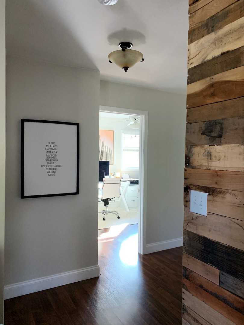 2119 Fairfield Road Lindenhurst, IL 60046 - Photo 10 of 22 a view of a hallway with wooden floor and a cabinet