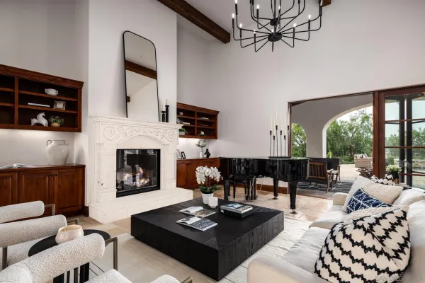 a living room with furniture fireplace and window