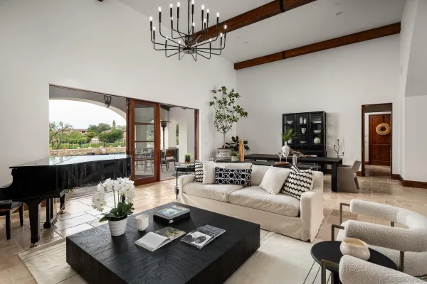 a living room with furniture large window and outdoor view