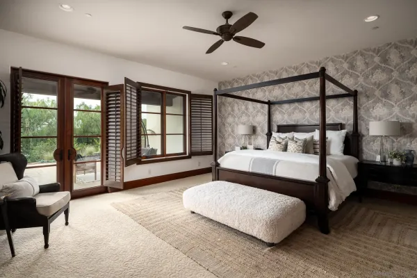 a bedroom with a bed and large window