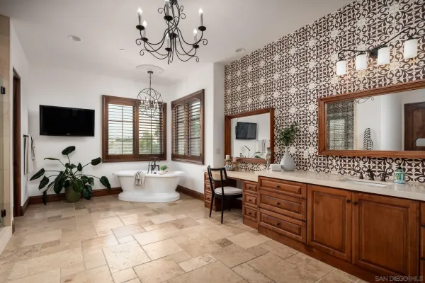 a spacious bathroom with a double vanity sink a large mirror and a bathtub
