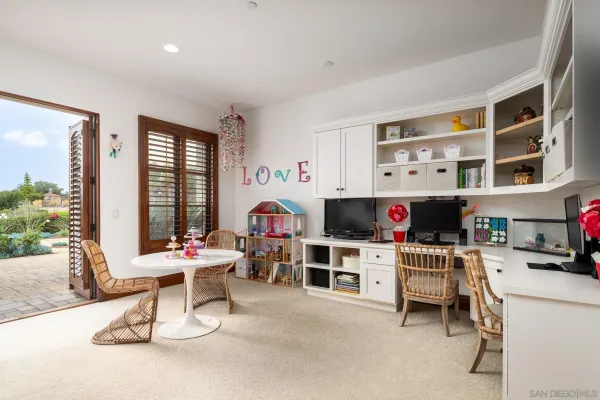 a work room with furniture and a flat screen tv