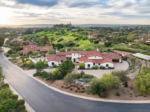 an aerial view of residential houses with outdoor space and street view