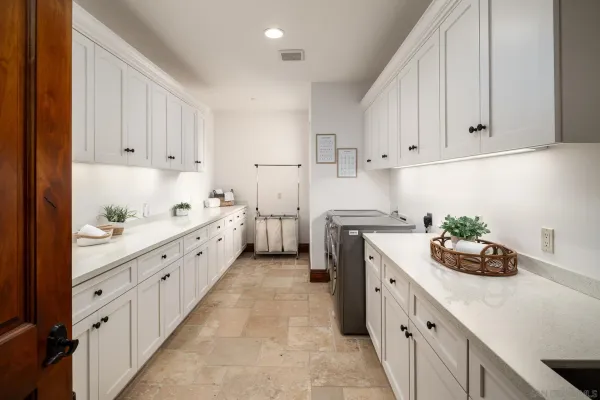 a kitchen with granite countertop white cabinets and white appliances