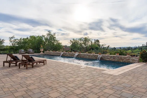 a view of a backyard with swimming pool