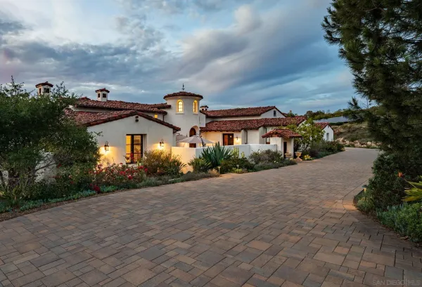 a front view of a house with a garden and plants