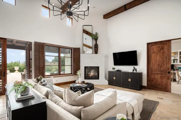 a living room with furniture a flat screen tv and a fireplace