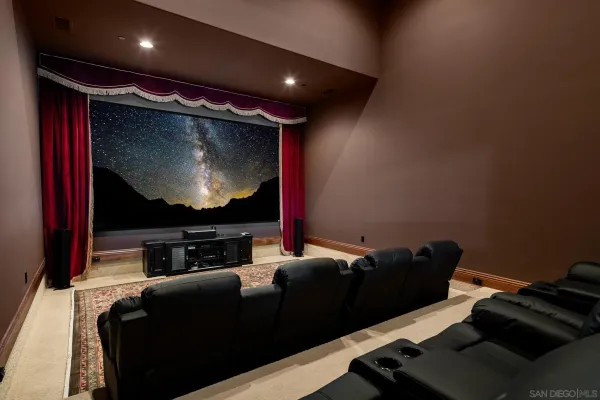 a room with furniture projector and screen