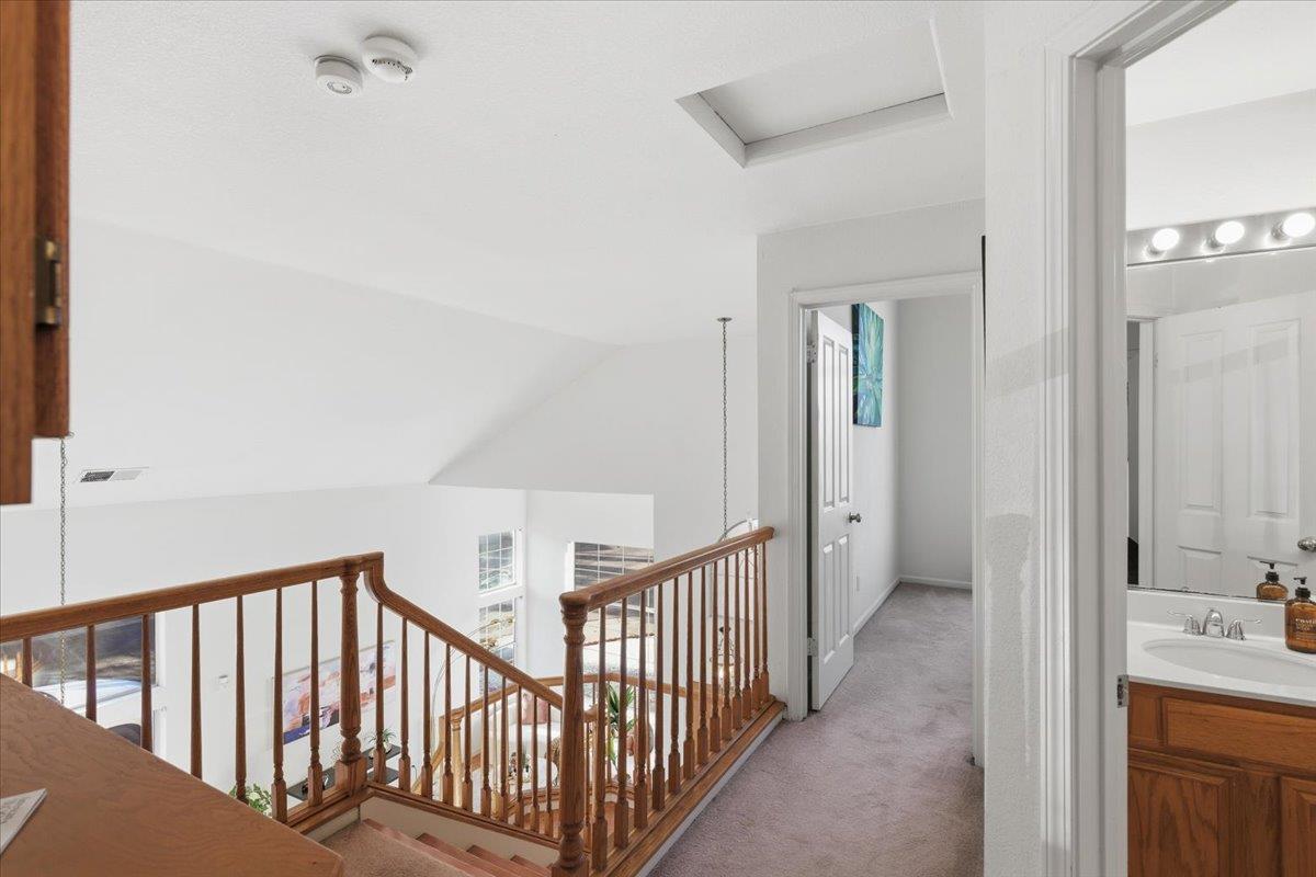 29273 Chance Street Hayward, CA 94544 - Photo 21 of 51 a view of a hallway with a sink and a mirror