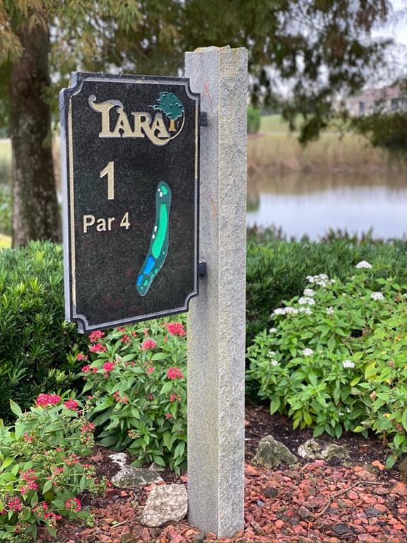 6713 Stone River Road, Unit 206 Bradenton, FL 34203 - Photo 49 of 58 a sign that is sitting in front of flowers