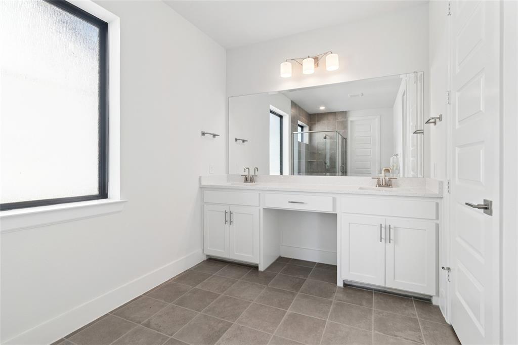 714 Resort Drive Rowlett, TX 75088 - Photo 12 of 30 a bathroom with a double vanity sink and a mirror