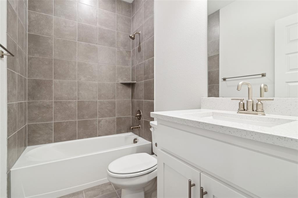 714 Resort Drive Rowlett, TX 75088 - Photo 14 of 30 a bathroom with a sink a toilet and bathtub