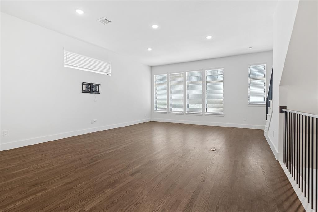 714 Resort Drive Rowlett, TX 75088 - Photo 6 of 30 an empty room with wooden floor and windows