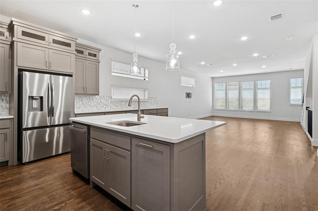 714 Resort Drive Rowlett, TX 75088 - Photo 7 of 30 a kitchen with kitchen island a sink appliances and cabinets