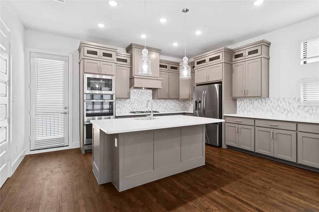 714 Resort Drive Rowlett, TX 75088 - Photo 9 of 30 a kitchen with stainless steel appliances a sink and a refrigerator