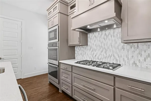 a kitchen with cabinets and a stove top oven