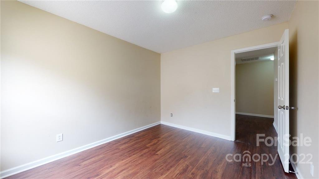 10619 Bedlington Road Charlotte, NC 28278 - Photo 16 of 26 an empty room with wooden floor and closet
