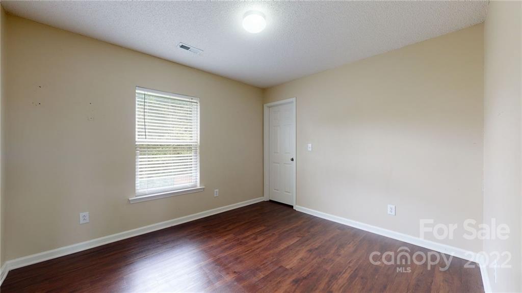 10619 Bedlington Road Charlotte, NC 28278 - Photo 17 of 26 an empty room with wooden floor and windows