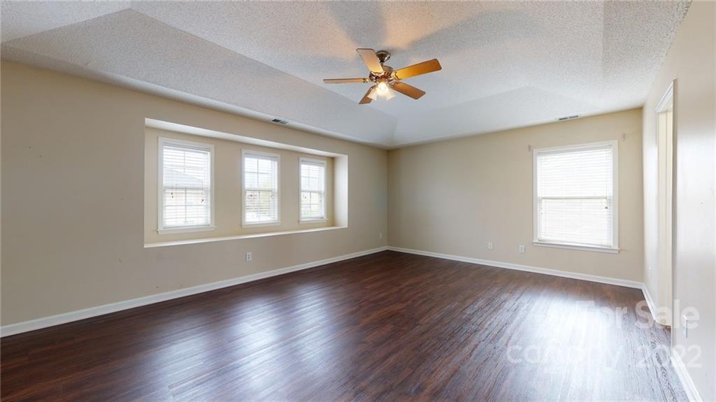 10619 Bedlington Road Charlotte, NC 28278 - Photo 20 of 26 a view of an empty room with wooden floor and a window