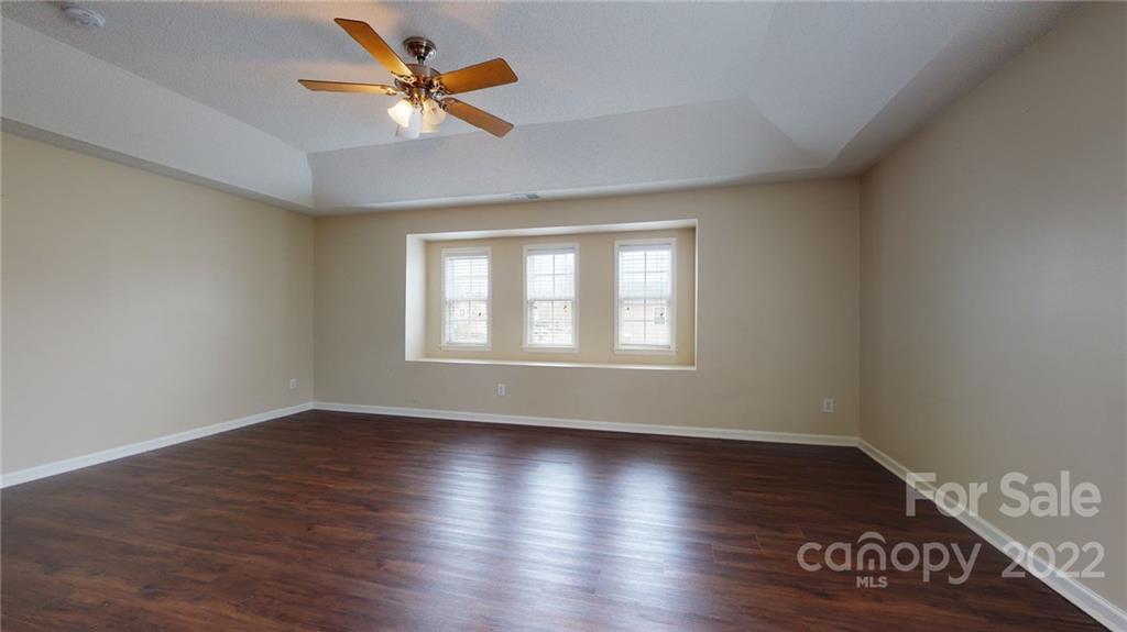 10619 Bedlington Road Charlotte, NC 28278 - Photo 21 of 26 an empty room with wooden floor and windows