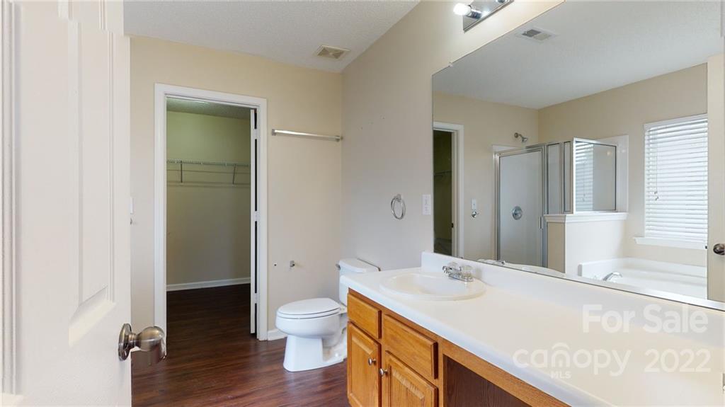 10619 Bedlington Road Charlotte, NC 28278 - Photo 22 of 26 a bathroom with a sink a toilet and shower