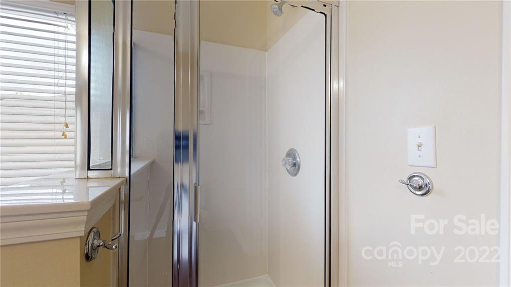 10619 Bedlington Road Charlotte, NC 28278 - Photo 24 of 26 a bathroom with a shower and a door