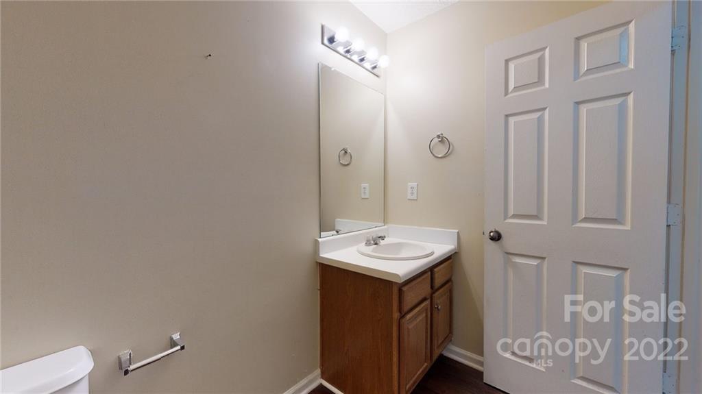 10619 Bedlington Road Charlotte, NC 28278 - Photo 25 of 26 a bathroom with a sink a toilet and a mirror