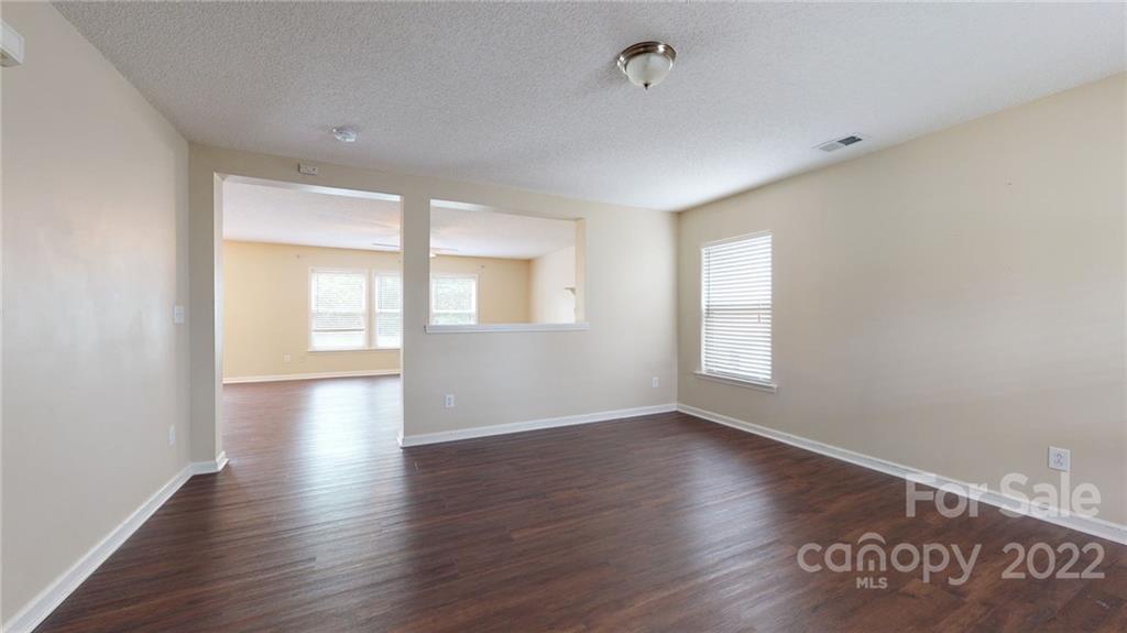 10619 Bedlington Road Charlotte, NC 28278 - Photo 5 of 26 a view of an empty room with window and wooden floor