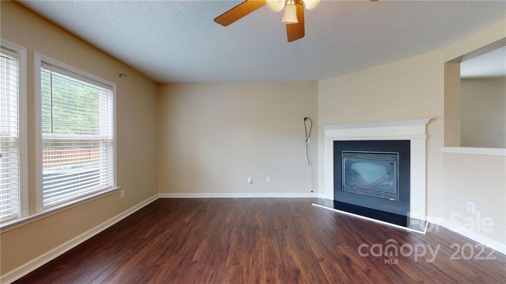 10619 Bedlington Road Charlotte, NC 28278 - Photo 7 of 26 a view of an empty room with window and wooden floor