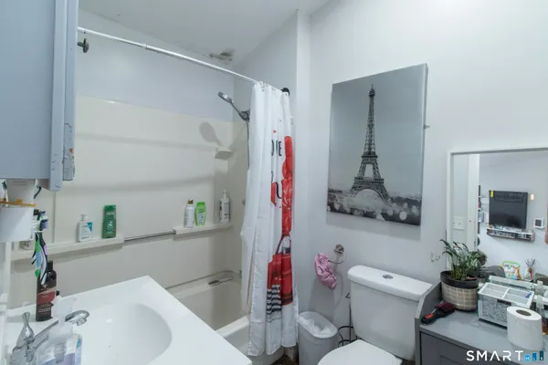 a bathroom with a sink toilet and shower