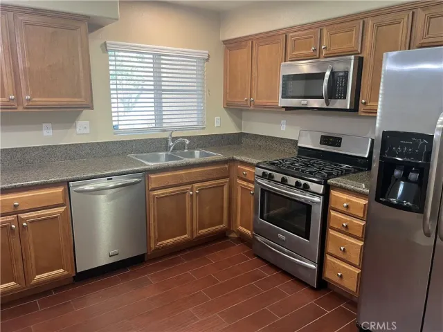a kitchen with granite countertop a sink and cabinets