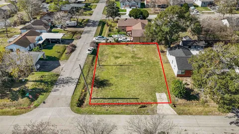 an aerial view of a residential houses with outdoor space