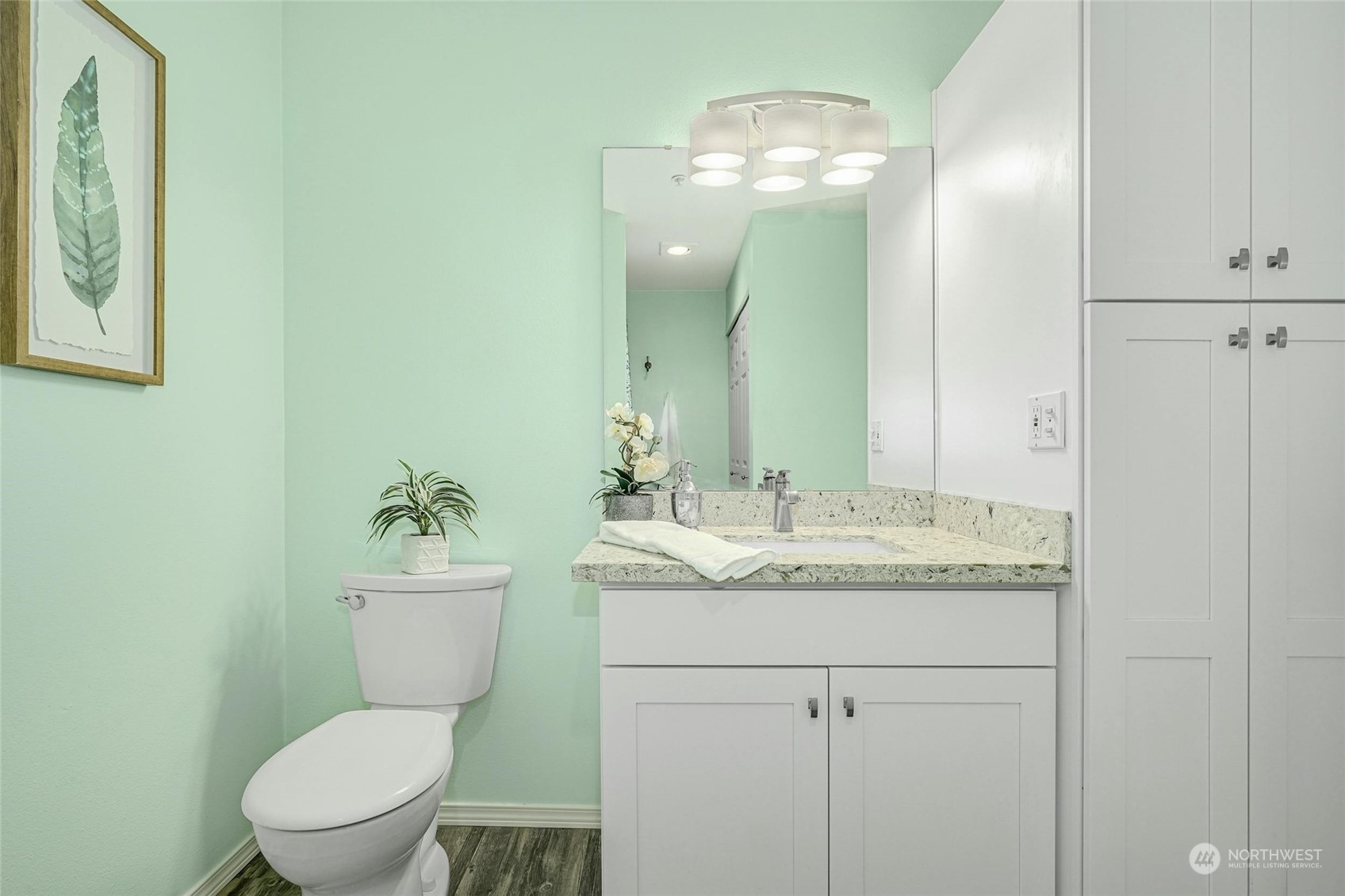 10709 Valley View Road, Unit A303 Bothell, WA 98011 - Photo 17 of 23 a bathroom with a granite countertop toilet sink and mirror