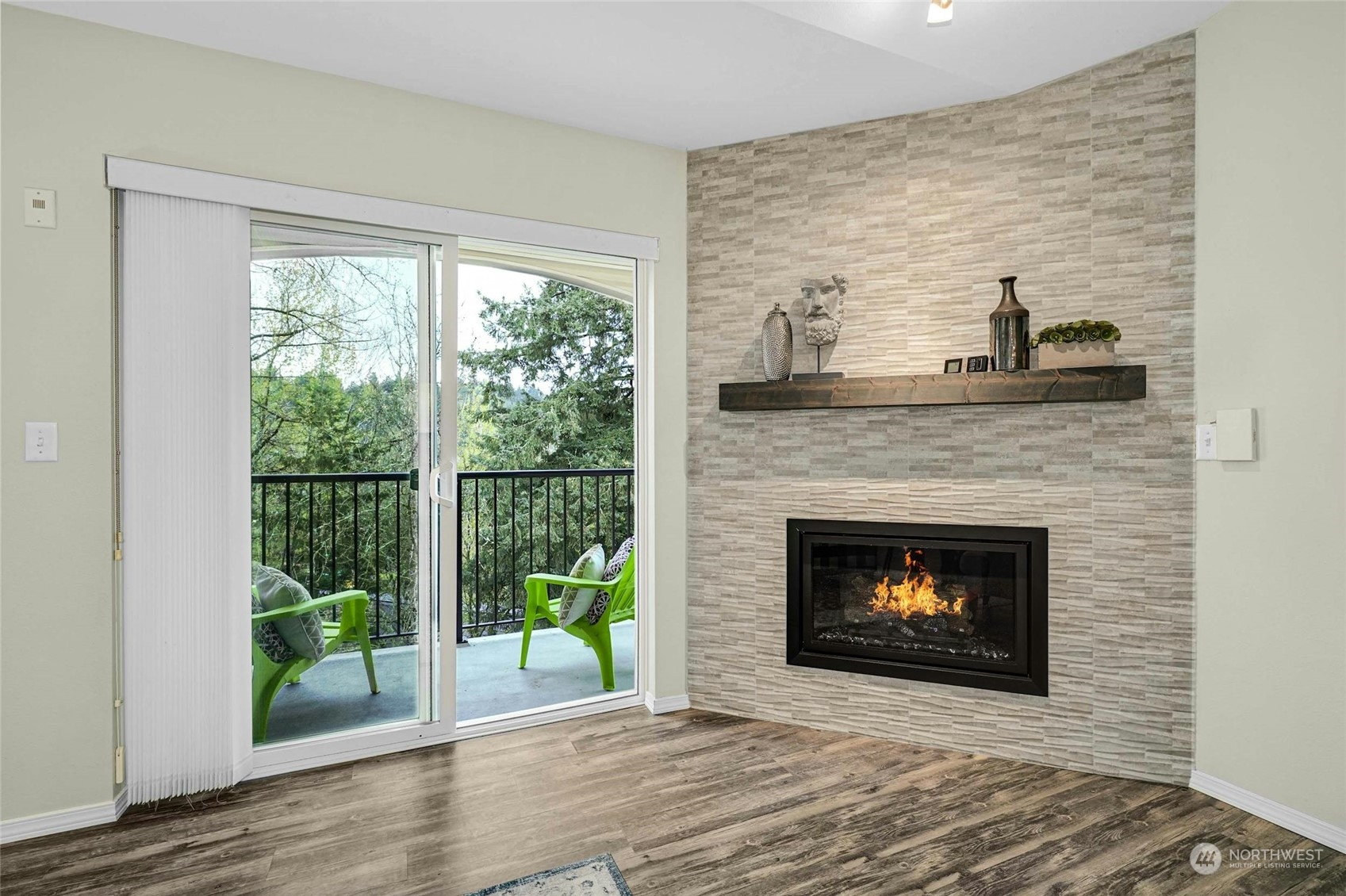 10709 Valley View Road, Unit A303 Bothell, WA 98011 - Photo 4 of 23 a living room with a fireplace and a floor to ceiling window