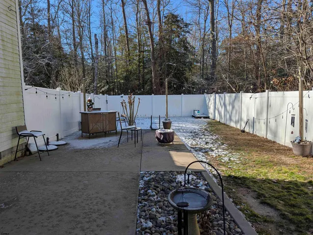 a view of a backyard with sitting area