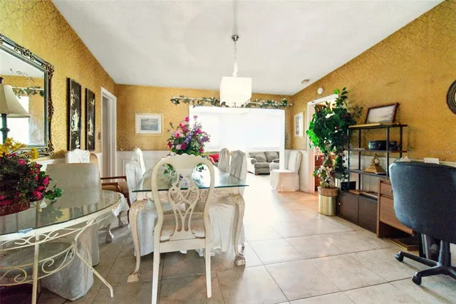 a view of a dining room with furniture and chandelier