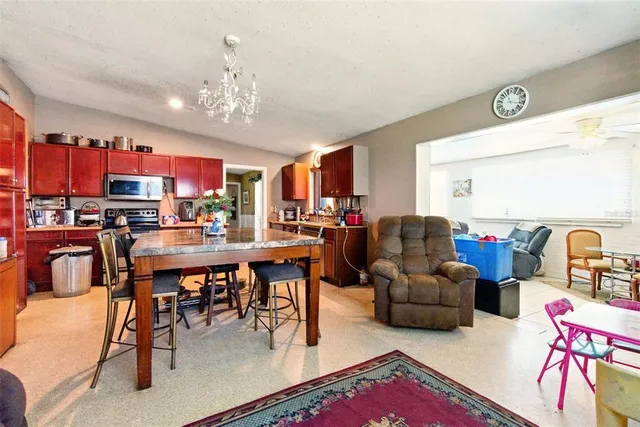 a living room with lots of furniture and kitchen view