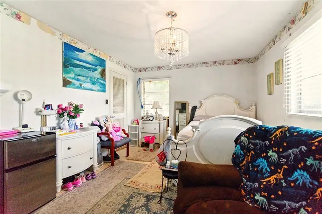 a bedroom with a bed and a chandelier