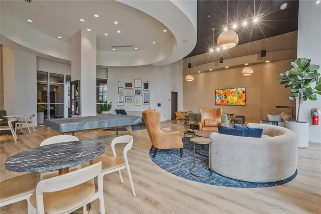 a living room with furniture and a potted plant